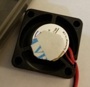 Cutting the 3M material to fit the top of the fan